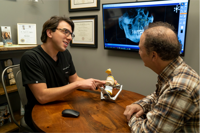 Doctor showing model of Teeth